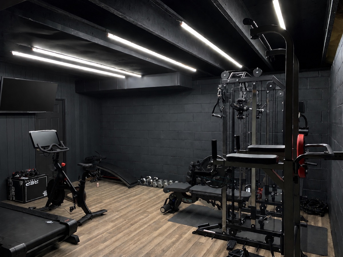Finished home gym with cardio and strength equipment